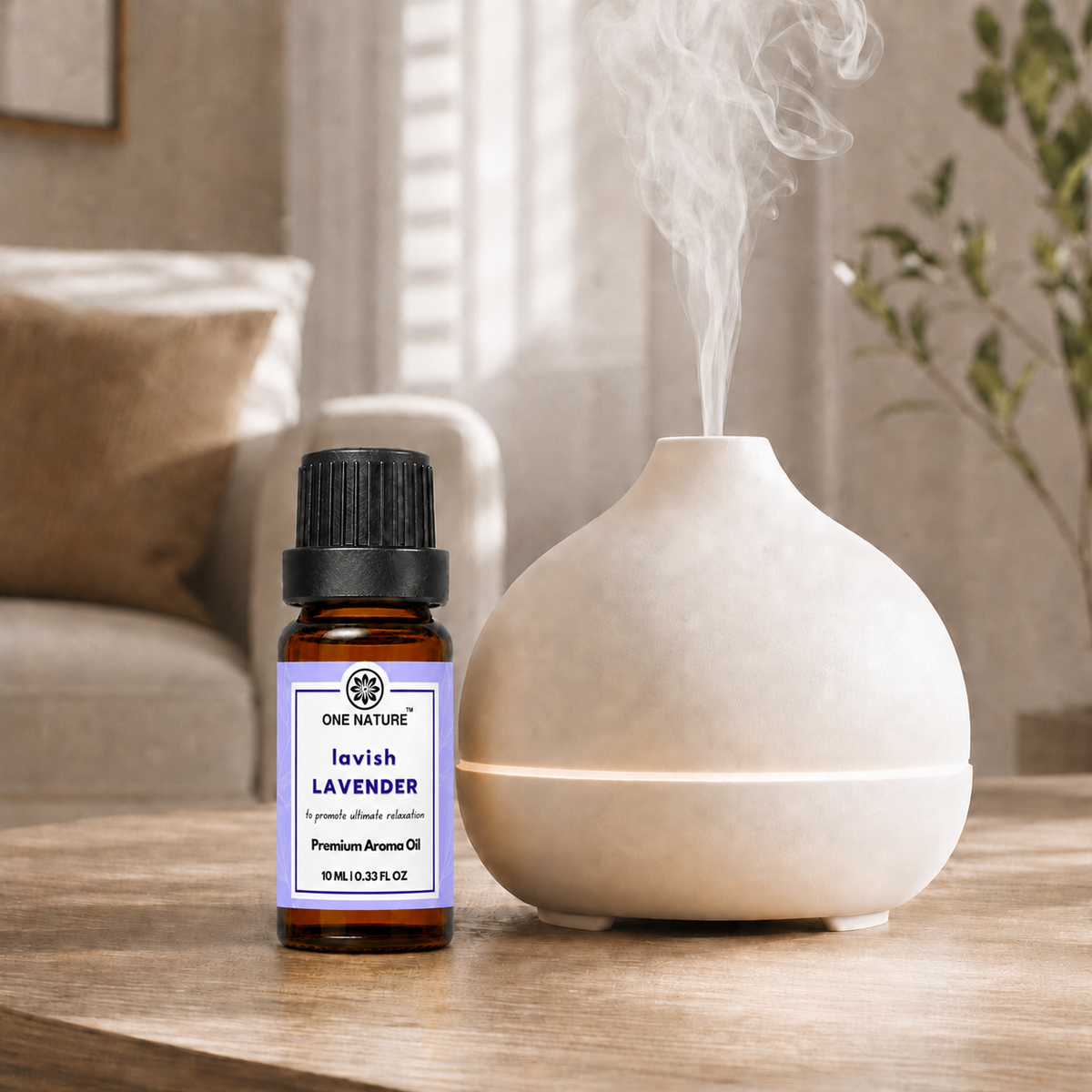 A bottle of One Nature Lavender Premium Aroma Oil stands next to a ceramic diffuser on a wooden table, with steam visibly rising from the diffuser in a softly lit home interior.