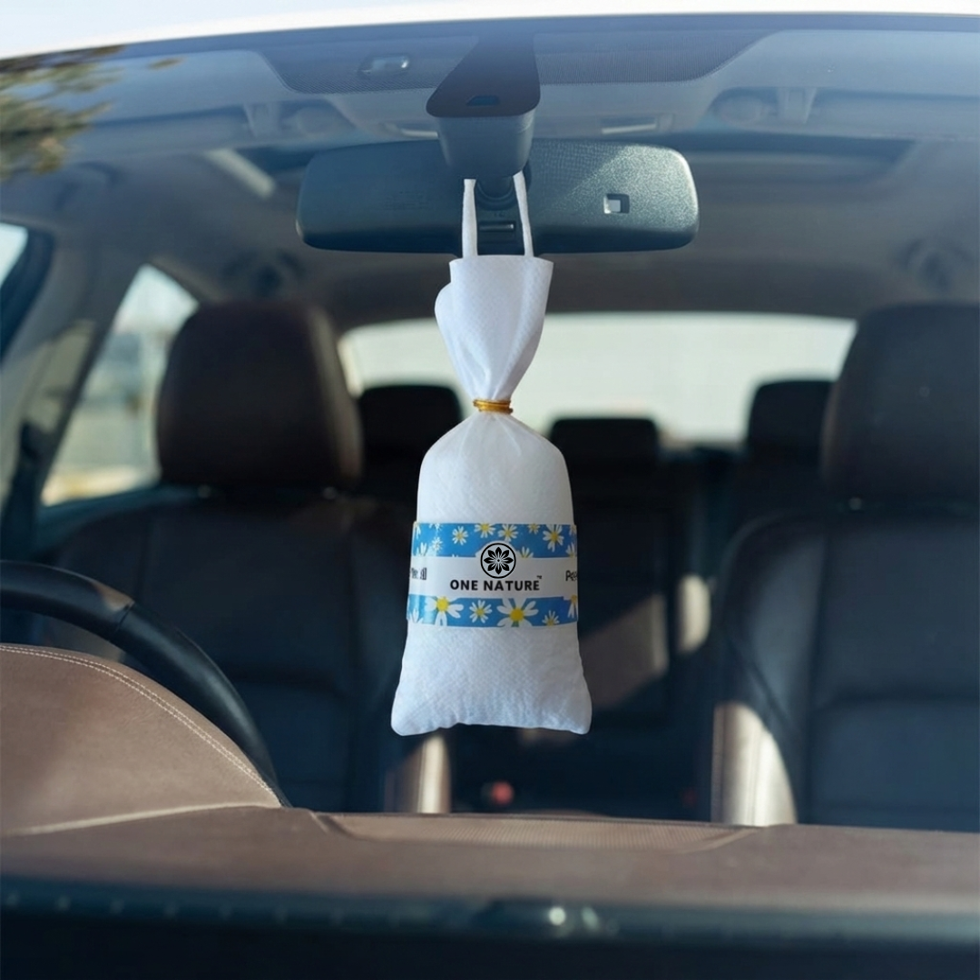 Car air freshener hanging from the rearview mirror of a vehicle