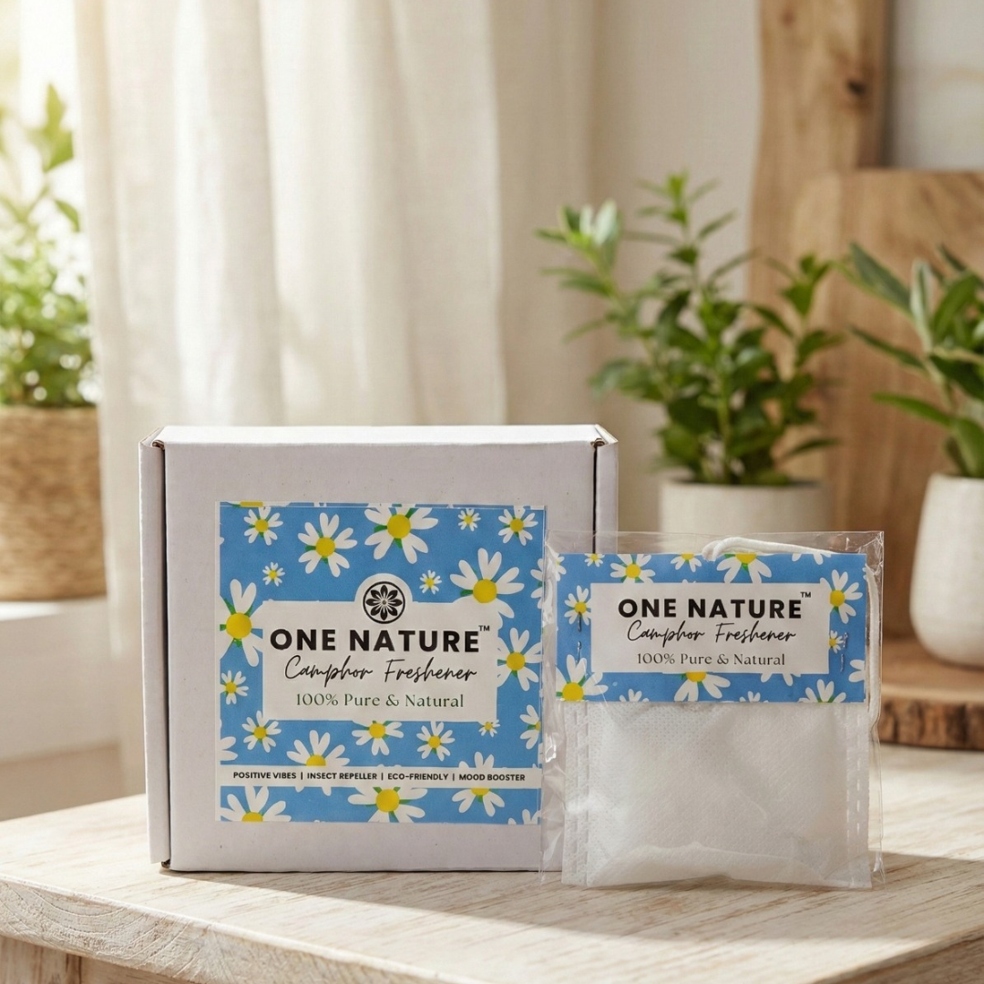 One Nature camphor freshener packaging on a wooden surface with plants in the background