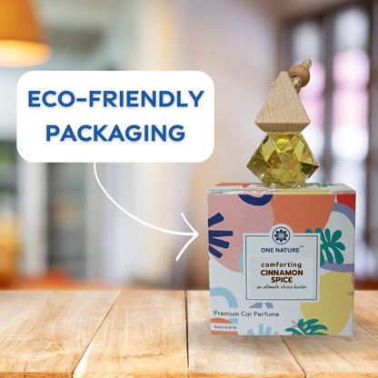 Eco-friendly cinnamon spice car perfume with colorful packaging on a wooden surface.