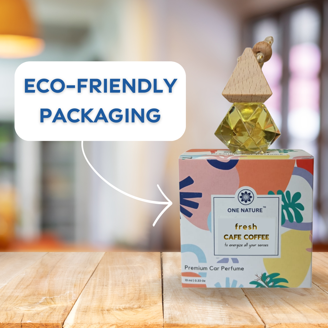 One Nature fresh Cafe Coffee car perfume with eco-friendly packaging on a wooden surface.