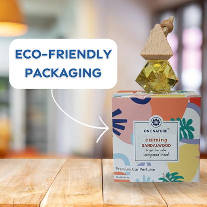 One Nature calming sandalwood car perfume with colorful packaging on a wooden surface.