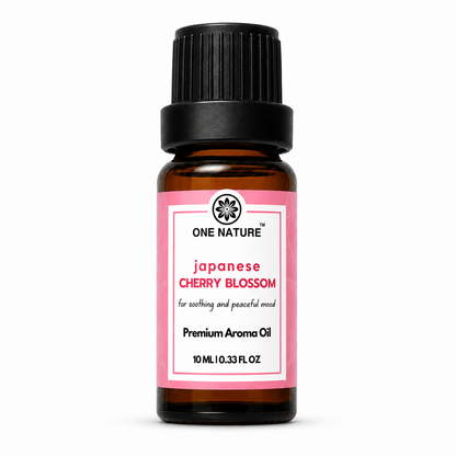 A 10 mL amber glass bottle of One Nature Japanese Cherry Blossom premium aroma oil with a black ribbed cap and a pink and white label, set against a plain white background.