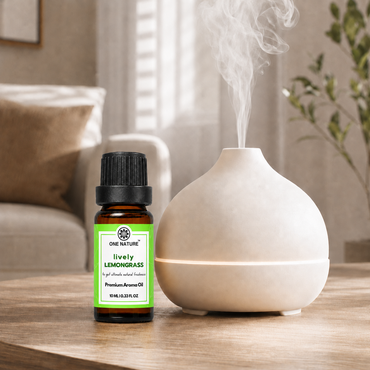 A small amber bottle of One Nature Lively Lemongrass essential oil stands beside a white ceramic diffuser on a wooden table in a softly lit living room. Steam rises from the diffuser, and the product label is clearly visible.