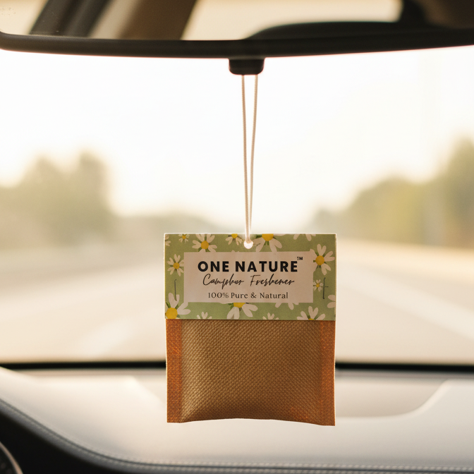 Car air freshener hanging from a car's rearview mirror with a visible brand label.