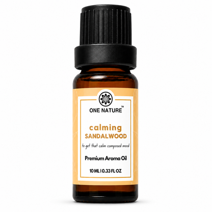 A 10 mL amber glass bottle of One Nature Calming Sandalwood Premium Aroma Oil with a black ribbed cap and a white label with orange accents, set against a plain white background.