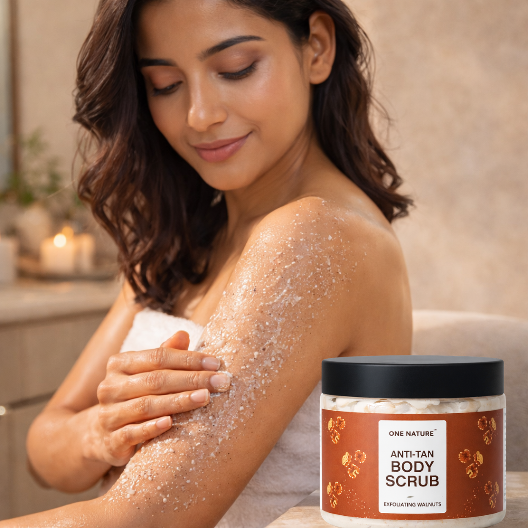 Woman applying body scrub to her arm with a jar of One Nature Anti-Tan Body Scrub in the foreground.