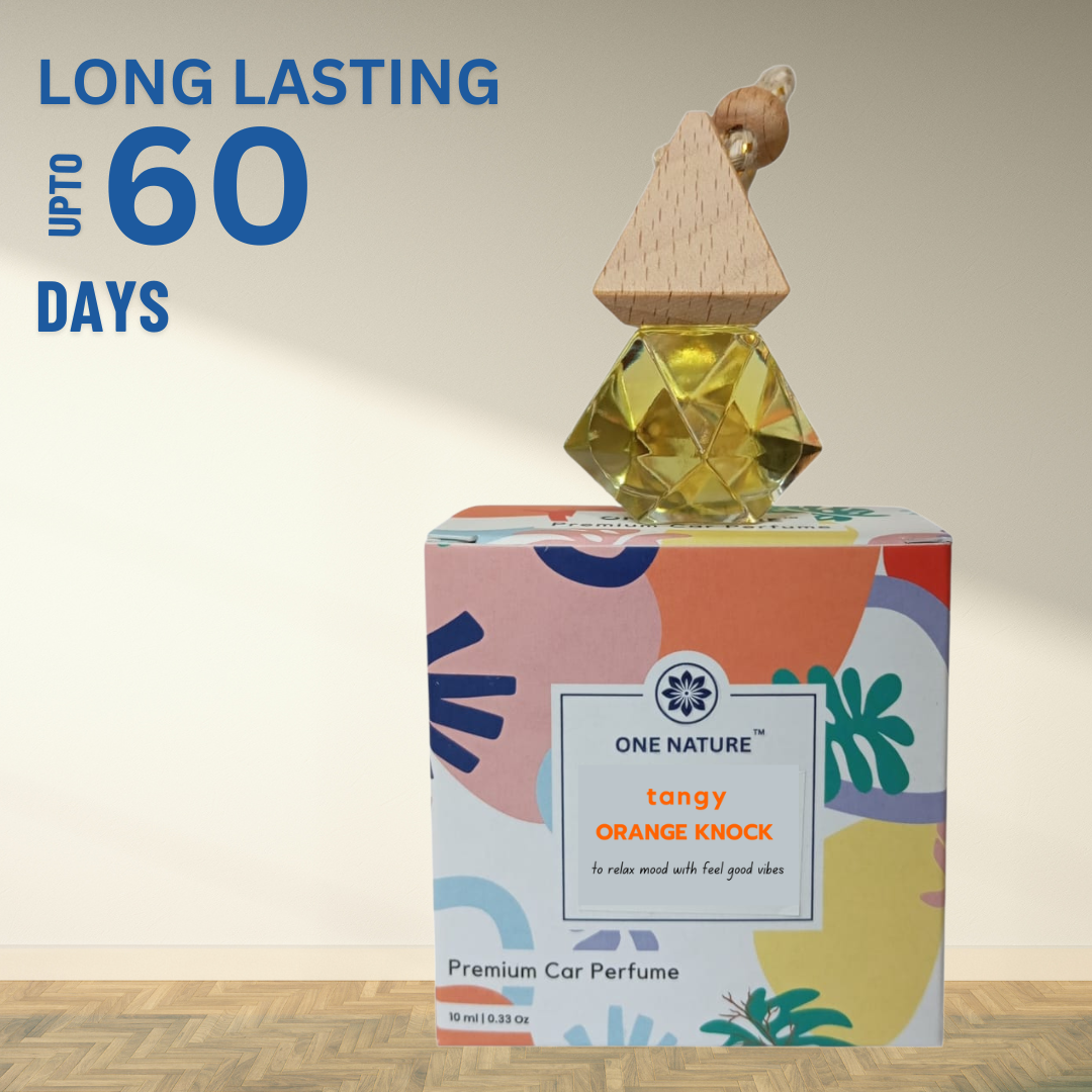 One Nature tangy orange knock car perfume with colorful packaging on a wooden surface.